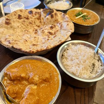 Sathi - Butter Chicken  - bottom; Garlic Naan, Lamb Tikka Masala - top - Indian Near Me - New York, New York