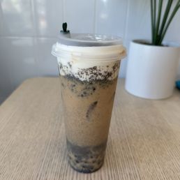 a cup of iced coffee on a table a cup of iced coffee on a table