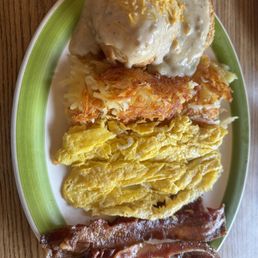 Papa bear with scrambled, bacon and hash browns beside biscuits and gravy Papa bear with scrambled, bacon and hash browns beside biscuits and gravy