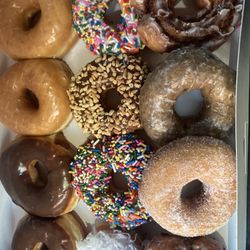 A dozen fancy assorted donuts.
