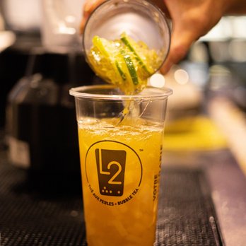 L2 Bubble Tea - Alexis Nihon - a person pouring a drink - Bubble Tea Near Me - Montreal, Quebec L2 Bubble Tea - Alexis Nihon - a person pouring a drink - Bubble Tea Near Me - Montreal, Quebec