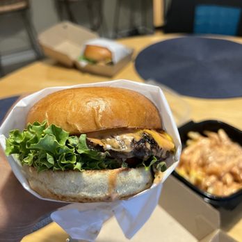 Fred's Burger - a hand holding a sandwich - Burgers Near Me - Fairfield, California