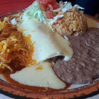 Photo of Rosa's Cafe & Tortilla Factory - Temecula, CA, United States. The hidden cheese enchilada under the red sauce and the chicken enchilada next to it. Yummm!!