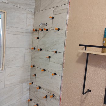 For His Glory - Applying and spacing the tiles to get the perfect levelness and spacing - Handyman Near Me