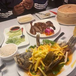 Half duck with pancakes and Thai fried fish with mango stir fry sauce and rice. Half duck with pancakes and Thai fried fish with mango stir fry sauce and rice.