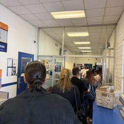 US Post Office - Long long line, one postal worker