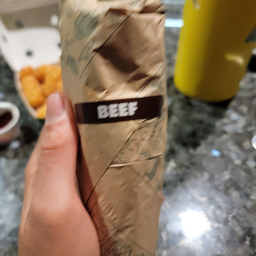 Taco Time - a person holding a bag of food - Mexican Near Me - Seattle, Washington Taco Time - a person holding a bag of food - Mexican Near Me - Seattle, Washington