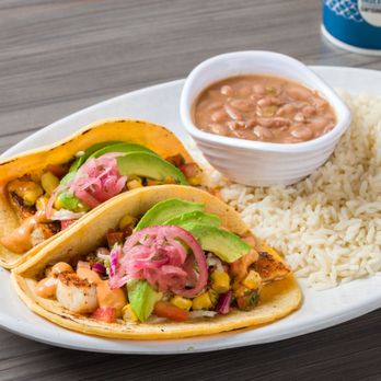 California Fish Grill - Mahi Mahi Taco Combo Cali-Style, grilled Mahi, tomato-cilantro mix, cilantro lime slaw, avocado corn salsa, chipotle aioli & pickled onions. - Seafood Near Me - Phoenix, Arizona