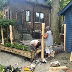 J & G Fence Services - Mixing concrete in the hole.