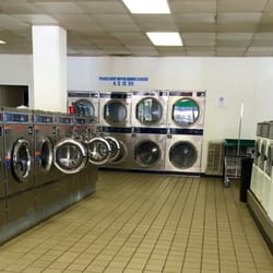 South Side Laundry - Lineup of newer machines on the left facing older ones on the right, with dryers at the end.