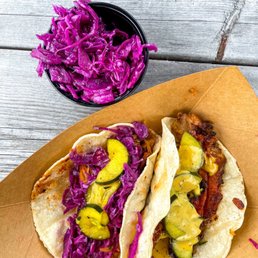 two tacos and a side of coleslaw