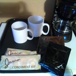 Coffee maker with two mugs, two condiment sets, and three coffee packets (no decaf options, though).