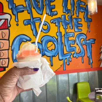Jeremiah's Italian Ice - a hand holding a sandwich - Desserts Near Me - West Melbourne, Florida