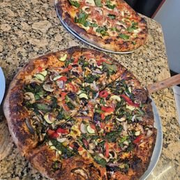 Top to bottom: Margherita pizza, Veggie pizza. Top to bottom: Margherita pizza, Veggie pizza.