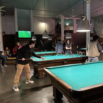 The Pharmacy - people playing pool in a large room - Cocktail Bars Near Me - Seattle, Washington