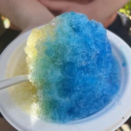 a person holding a plate of shaved ice