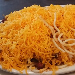 Chili on a bed of spaghetti beans onions cheddar
