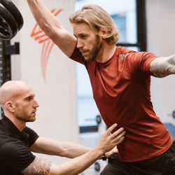 Zach Moore Personal Training - Form is critical, especially when you're pressing heavy weight over your head. Here I am cueing Paul to engage his core to protect his back.