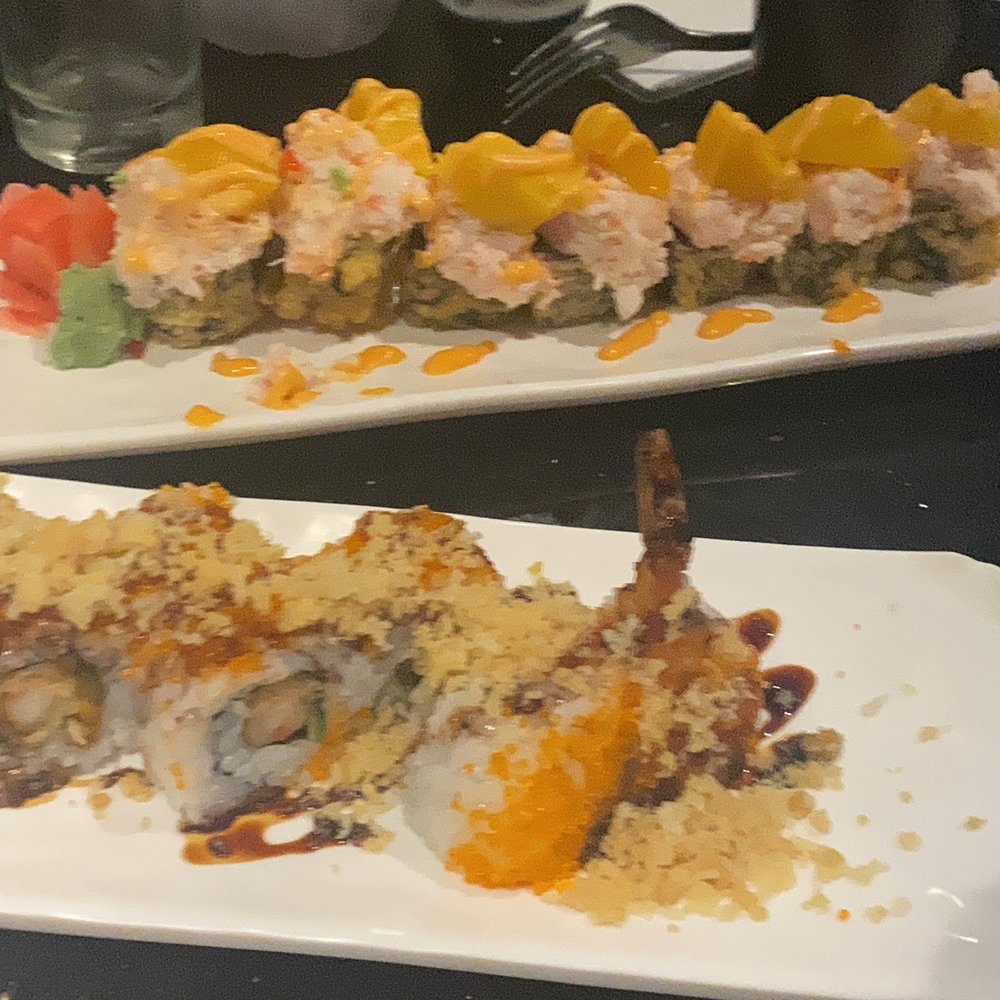 two plates of sushi on a table two plates of sushi on a table