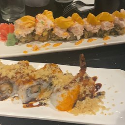 two plates of sushi on a table two plates of sushi on a table