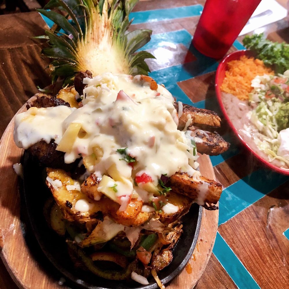 El Rincon Tacos & Grill - Their Pineapple Fajitas-a hollowed out fresh pineapple filled with chicken steak and shrimp. - Mexican Near Me - Theodore, Alabama El Rincon Tacos & Grill - Their Pineapple Fajitas-a hollowed out fresh pineapple filled with chicken steak and shrimp. - Mexican Near Me - Theodore, Alabama