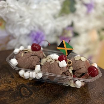 Scoop N Sip - Sundae- Chocolate Ice cream, slivered almonds, mini marsh-mellows, maraschino cherries, chocolate Pirouette, and a mini Jamaican Flag. - Ice Cream & Frozen Yogurt Near Me - New York, New York Scoop N Sip - Sundae- Chocolate Ice cream, slivered almonds, mini marsh-mellows, maraschino cherries, chocolate Pirouette, and a mini Jamaican Flag. - Ice Cream & Frozen Yogurt Near Me - New York, New York
