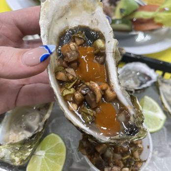 El Camaron Loco - a person holding an oyster - Mexican Near Me - Aurora, Colorado El Camaron Loco - a person holding an oyster - Mexican Near Me - Aurora, Colorado
