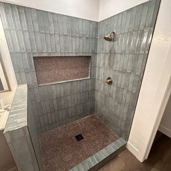 Tile Perfected - Glazed ceramic with a copper penny round, black trim, and brass fixtures. - General Contractors Near Me - Prescott Valley, Arizona Tile Perfected - Glazed ceramic with a copper penny round, black trim, and brass fixtures. - General Contractors Near Me - Prescott Valley, Arizona