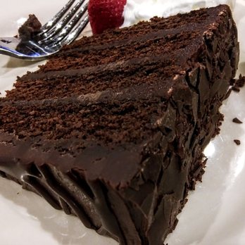 Old Chicago Pizza + Taproom - a slice of chocolate cake with whipped cream and raspberries - Pizza Near Me - Chandler, Arizona