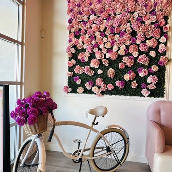 Cafe Lola - a bicycle parked in front of a floral wall - Cafes Near Me - Henderson, Nevada