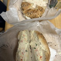 Everything bagel with vegetable cream cheese and everything bagel with lox spread