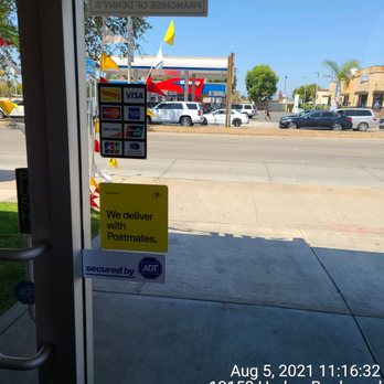Denny's - a view of a gas station through a glass door - Diners Near Me - Garden Grove, California