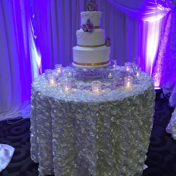 Simply Elegant - Cake table with the beautiful wall lighting in background - Wedding Planning Near Me