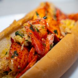 The Corner Boyz - Elevate your coastal culinary experience with our Garlic Butter Lobster Roll. Succulent Atlantic lobster, drenched in rich garlic butter.