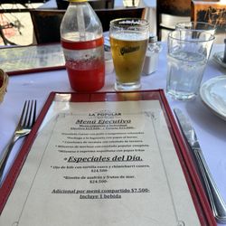 The menu, sparkling water and of course a Quilmes beer