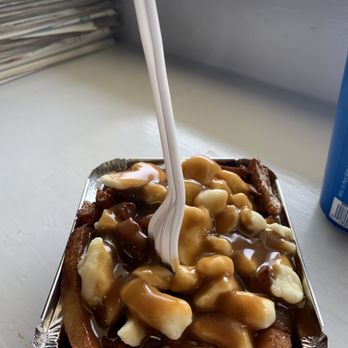 La Belle Patate - a container of french fries with caramel sauce and bananas - Fast Food Near Me - Victoria, British Columbia La Belle Patate - a container of french fries with caramel sauce and bananas - Fast Food Near Me - Victoria, British Columbia