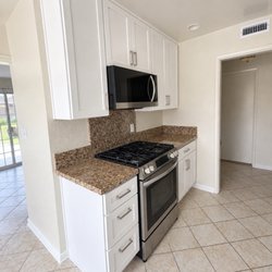 Anna Dwinger Interiors - New cabinets and countertop in a rental after a flood.