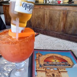 a bottle of beer being poured into a margarita a bottle of beer being poured into a margarita