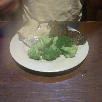 Logan's Roadhouse - New York strip steak medium well with broccoli and a baked potato - Steakhouses Near Me - Chattanooga, Tennessee