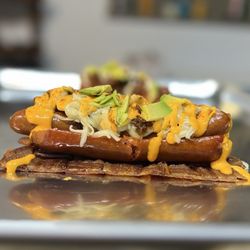 Frankin It Up - Frankinator...woven bacon, topped with a split Louisiana frank, stuffed with a petite boars head link, avocado, cheese and sriracha mayo!'