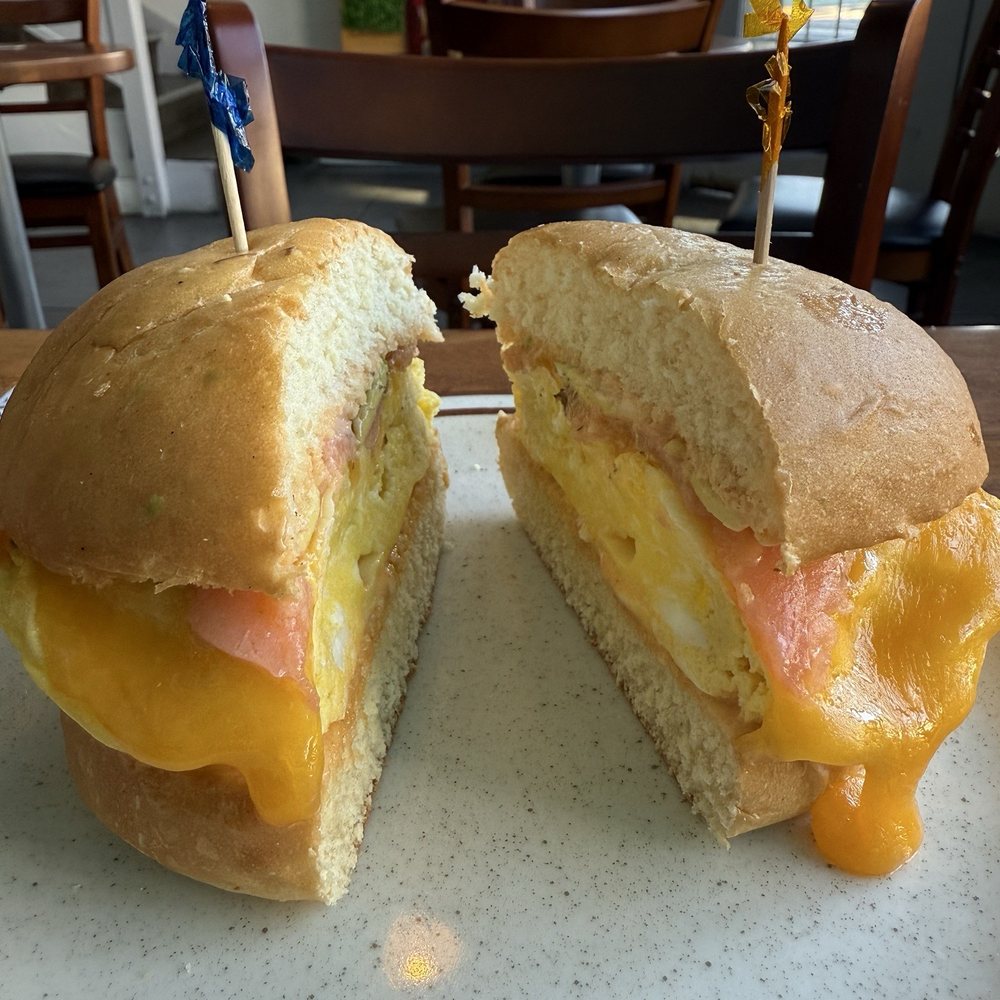 Salmon, egg, cheese sandwich on brioche with spicy aioli. Salmon, egg, cheese sandwich on brioche with spicy aioli.