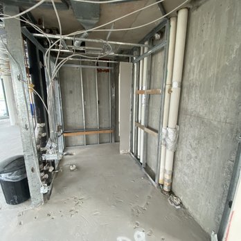 Bisceglia Contracting - an unfinished building with pipes and pipes - General Contractors Near Me