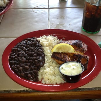 The Conch House Restaurant - Blackened mahi-mahi with black beans and coconut rice. - Caribbean Near Me - Saint Augustine, Florida The Conch House Restaurant - Blackened mahi-mahi with black beans and coconut rice. - Caribbean Near Me - Saint Augustine, Florida