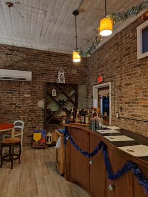 Inside Our Tasting Room - Get away to our charming winery, which is modeled after Tuscany, and enjoy a journey of wine and relaxation. Our historic building from 1932 has been fixed up to make it a warm and welcoming place for wine lovers who want to try something different. Immerse yourself in a cozy and elegant environment while enjoying locally made wine. With music playing in the background, our charming Tuscany space is the perfect place to unwind and enjoy an unforgettable experience. Inside Our Tasting Room - Get away to our charming winery, which is modeled after Tuscany, and enjoy a journey of wine and relaxation. Our historic building from 1932 has been fixed up to make it a warm and welcoming place for wine lovers who want to try something different. Immerse yourself in a cozy and elegant environment while enjoying locally made wine. With music playing in the background, our charming Tuscany space is the perfect place to unwind and enjoy an unforgettable experience.