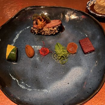 Next - a plate of food on a table - New American Near Me - Chicago, Illinois