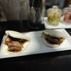 Roasted Duck Buns: Steamed Chinese bao buns, roasted duck, cucumber, pickled carrots & daikon, cilantro, hoisin sauce