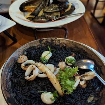 Mompou Tapas Bar & Restaurant - Mussels in the back, squid ink paella in the front - Spanish Near Me - Newark, New Jersey Mompou Tapas Bar & Restaurant - Mussels in the back, squid ink paella in the front - Spanish Near Me - Newark, New Jersey