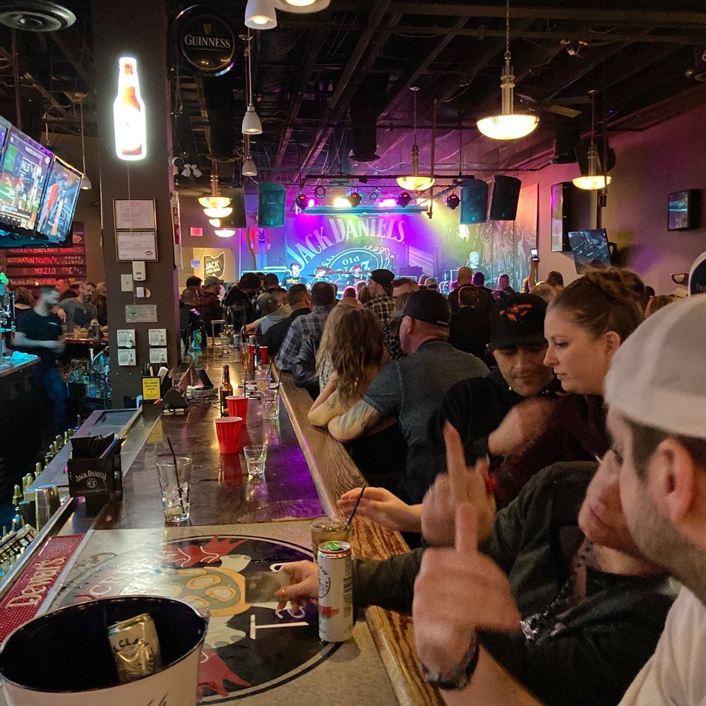 a group of people sitting at a bar a group of people sitting at a bar