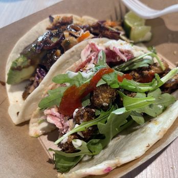 The Peached Tortilla - Asian chicken taco on left and cauliflower taco in foreground - Tacos Near Me - Austin, Texas The Peached Tortilla - Asian chicken taco on left and cauliflower taco in foreground - Tacos Near Me - Austin, Texas