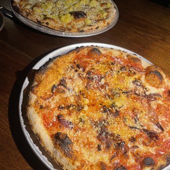 Contrada - two pizzas sitting on a table - Cocktail Bars Near Me - Asheville, North Carolina